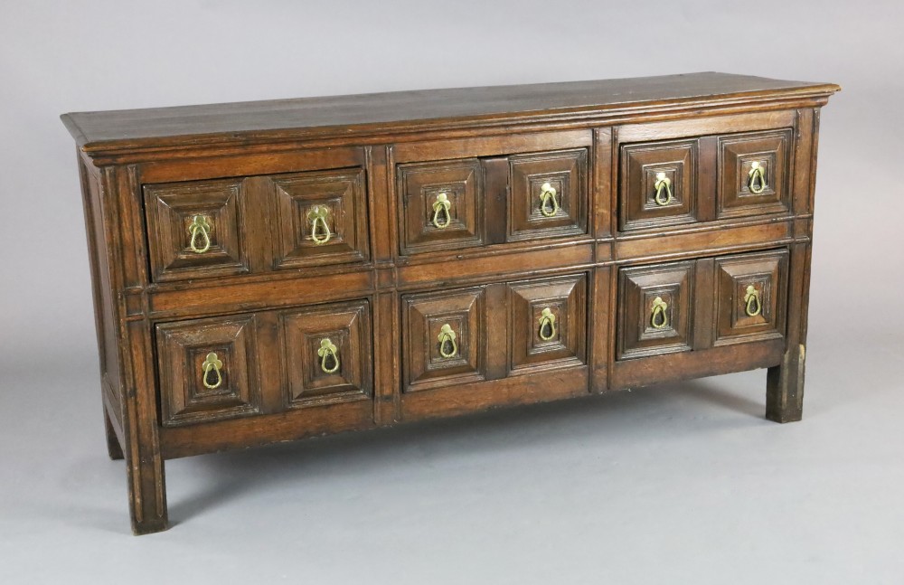 A 17th century style oak dresser base, fitted six geometric moulded drawers with drop handles, on stile feet, W.5ft 8in. D.1ft 9in. H.2